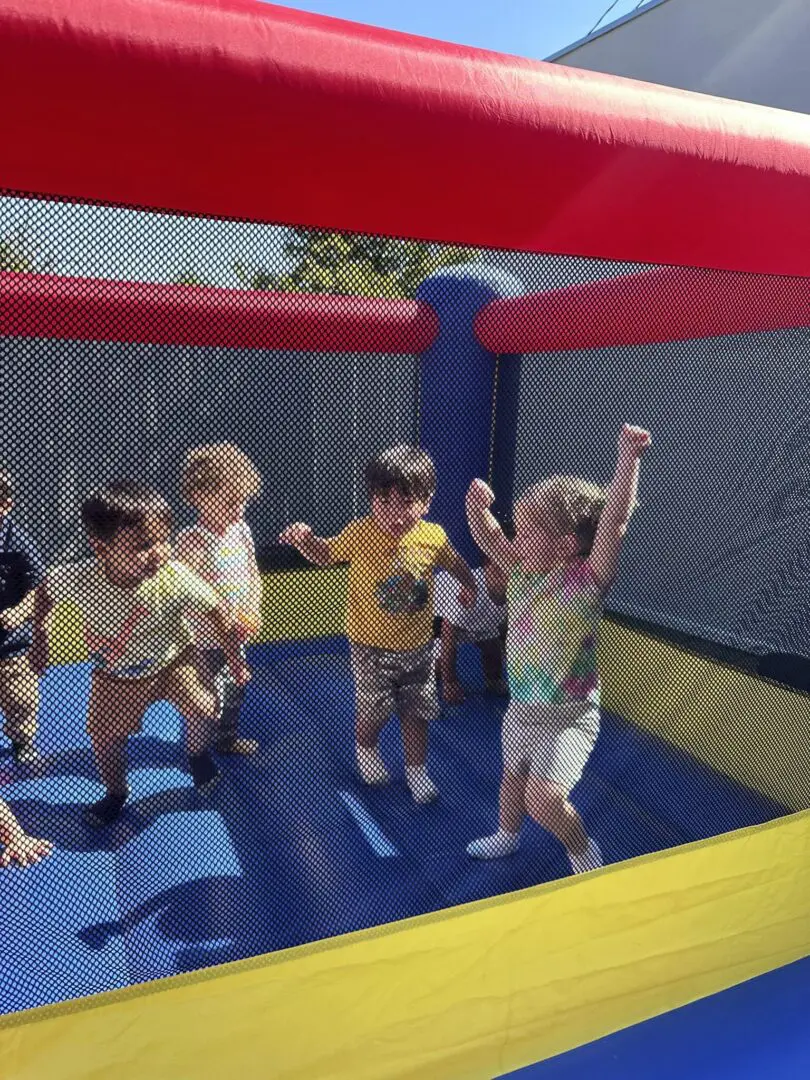 Kids playing in a colorful bounce house.